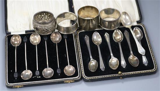 Two sets of six George V silver coffee spoons, three silver napkin rings, a Chinese napkin ring and a silver teaspoon.